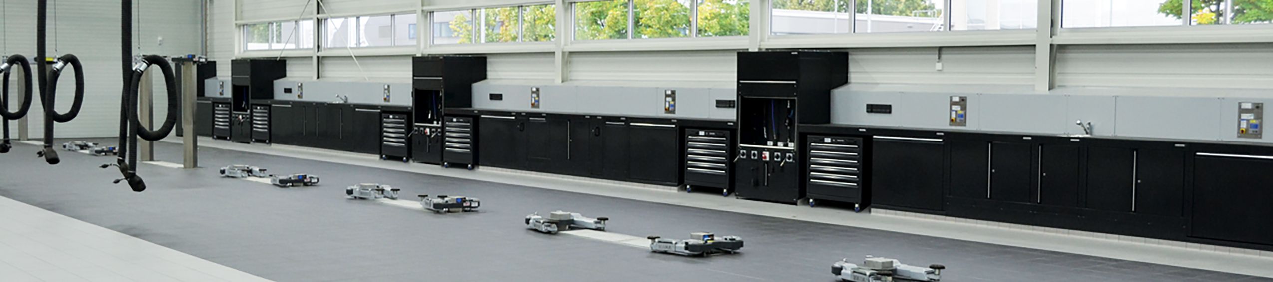 Black automotive tool cabinets in workshop by Dura Ltd